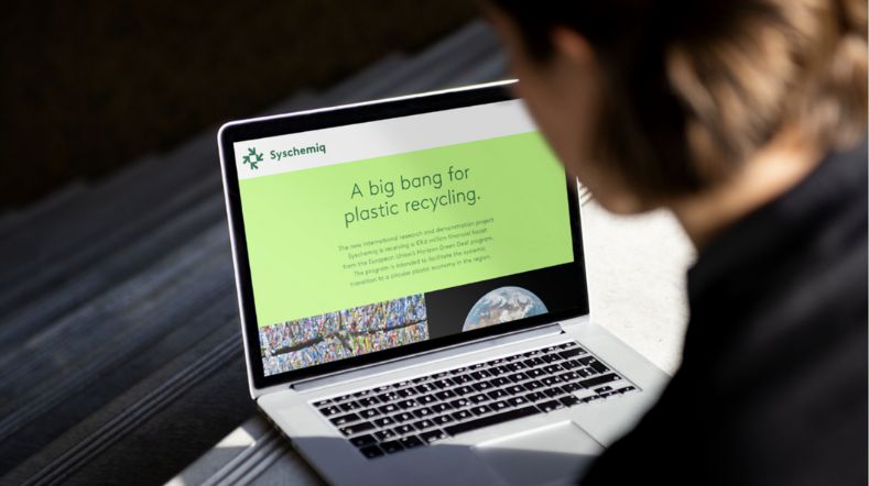 Woman behind laptop with the text 'a big bang for plastic recycling'