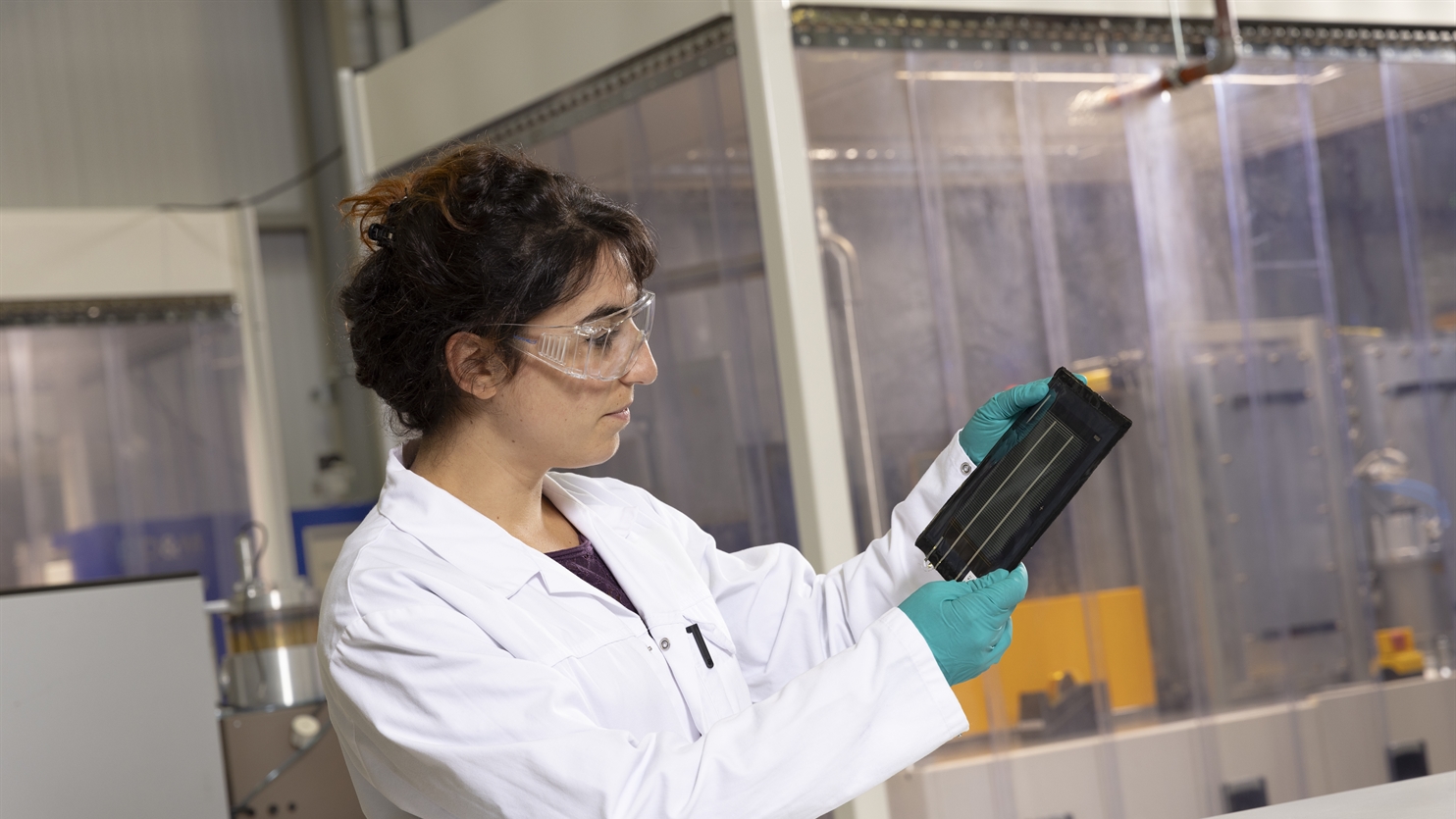 Scientist holds a solar cell